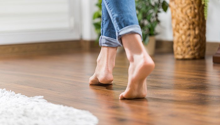 Homeowner walking on flooring in Sioux Falls home variable climate